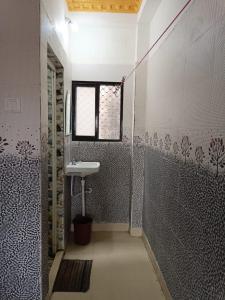 een badkamer met een wastafel en een douche bij Goroomgo Sri Ram Guest House Puri in Puri
