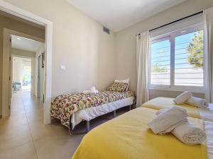 two beds in a room with a window at Villa Elisa - 3510 in Mar de Cristal +52 photos