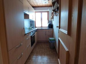a small kitchen with a sink and a window at Apartment in Hochf gen with a terrace in Hochfugen