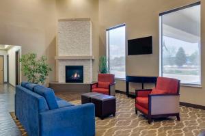 a lobby with three chairs and a fireplace at Comfort Inn Bozeman near University in Bozeman
