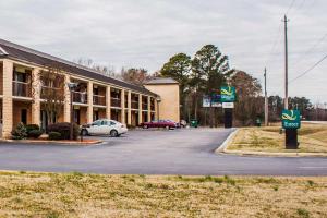 a building with a car parked in a parking lot at Quality Inn Kinston Hwy 70 in Kinston