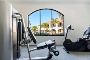a room with a gym with a chair and a window at Quality Resort Siesta in Albury