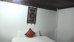a bed with a banner hanging on a wall at MUONG HOA Peaceful HOMESTAY & Sapa in Lao Cai
