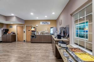 a large room with a kitchen with a counter at Sleep Inn & Suites Green Bay South in De Pere