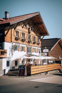 a building with a sign in front of it at Hotel Tradizio in Mittelberg