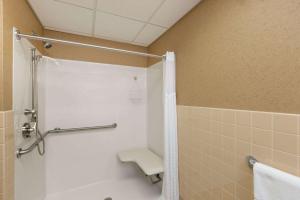 a bathroom with a shower and a bath tub at Travelodge by Wyndham Deadwood in Deadwood