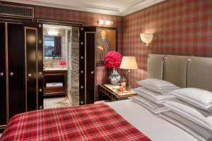 a bedroom with a bed and a portrait of a man at 100 Princes Street in Edinburgh