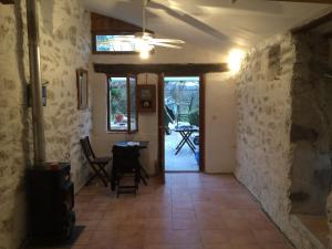a hallway with a table and chairs in a house at Cadierecevenne in La Cadière
