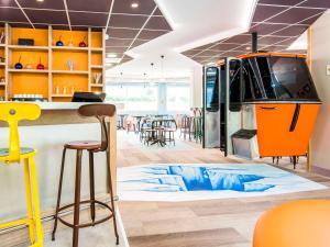 a large room with a food truck on the floor at Ibis Styles Sallanches Pays du Mont-Blanc in Sallanches