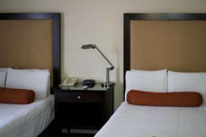奧克蘭的住宿－華盛頓旅館，配有2张床位的酒店客房,配有灯和电话