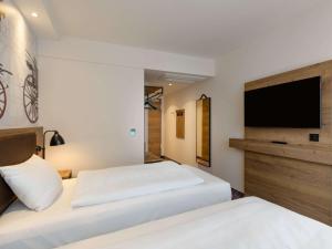 Postel nebo postele na pokoji v ubytování ibis Styles Coburg