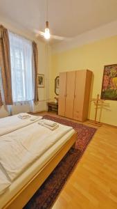 a bedroom with a large bed and a large window at Kamil Apartments, Delux A, 65m2 in Karlovy Vary