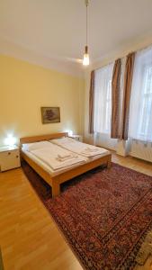 a large bed in a room with a rug at Kamil Apartments, Delux A, 65m2 in Karlovy Vary