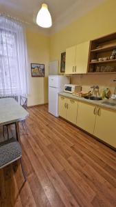 a kitchen with white appliances and a table and a table and a table at Kamil Apartments, Delux A, 65m2 in Karlovy Vary