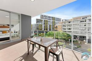 a dining room with a table and chairs and a large window at Aircabin - Mascot - Walk to Station - 3 Beds Apt in Sydney