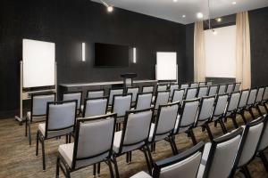 a conference room with chairs and a flat screen tv at Hyatt Place Nashville/Green Hills in Nashville