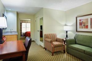 a living room with a couch and a chair at Country Inn & Suites by Radisson, Rock Falls, IL in Rock Falls