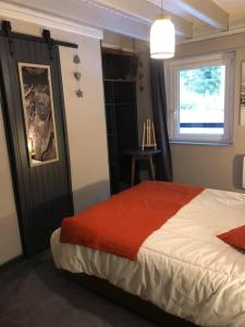 a bedroom with a bed and a window and a table at Le CHALET Apart Hotel Autonome in Gerbépal