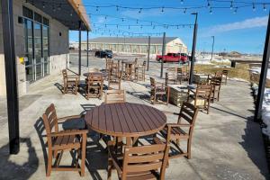 a group of tables and chairs sitting outside of a building at Comfort Inn & Suites at Sanford Sports Complex in Sioux Falls