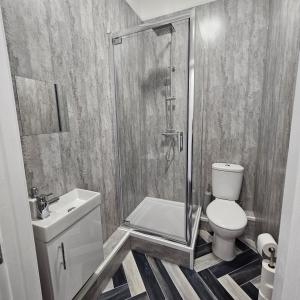 a bathroom with a shower and a toilet and a sink at Lyndhurst Terrace, Sunderland in Trimdon Grange