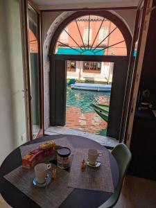 a table with two cups on it with a view of a pool at Piccola Perla sul Canale in Venice