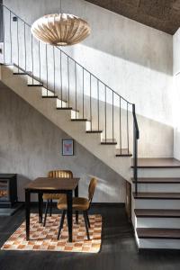 a dining room with a table and a staircase at E. Gray house in Dungarvan