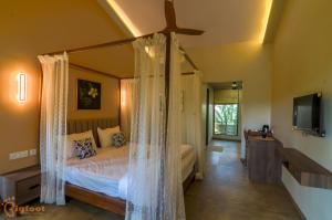 um quarto com uma cama de dossel em Jomo Resort em Alibag