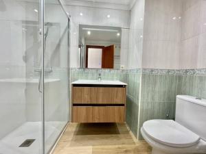 a bathroom with a shower and a toilet and a sink at LaFrenchTouch - Céntrico y moderno cerca del tren in Benalmádena