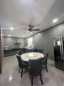 a dining room with a table and chairs and a ceiling at 1717 Bintulu Homestay 11 in Bintulu