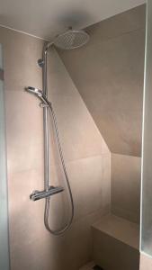 een douche met een douchekop in de badkamer bij Apartment über 2 Etagen nahe Messe und Stadion in Dortmund