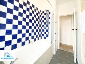 a checkered wall in a hallway with a checkered floor at Free Parking - Family Stays - Spacious in Harrogate