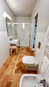 a bathroom with a toilet and a sink and a shower at Serra Country House in Gradara
