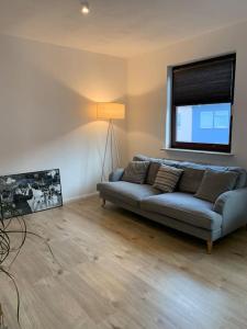 a living room with a couch and a window at Stilvolle Wohnung mit Balkon & Parkplätzen in Bremen