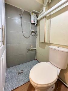 a small bathroom with a toilet and a shower at Chubby 5 Room 3 in Bang O