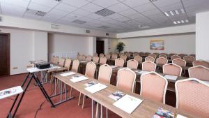 a room with a row of tables and chairs at Kontakt Wellness Hotel in Tatranská Lomnica +54 photos