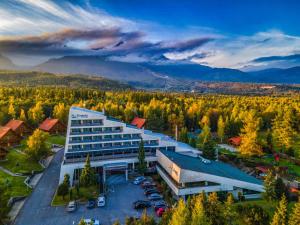 an aerial view of a building with a parking lot at Kontakt Wellness Hotel in Stará Lesná