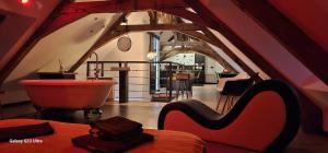a room with a bathroom with a tub and a table at Apparthotel loft Martigné-Ferchaud in Martigné-Ferchaud +4 photos