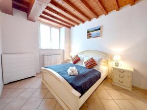 Vista sul Lago di Endine في Ranzanico: غرفة نوم فيها سرير مع قطه جالسه عليه