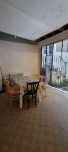 a room with a table and chairs in a room with windows at Maison cœur de ville aux Portes du Morvan in Corbigny