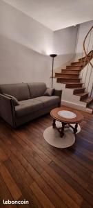 a living room with a couch and a coffee table at Maison cœur de ville aux Portes du Morvan in Corbigny