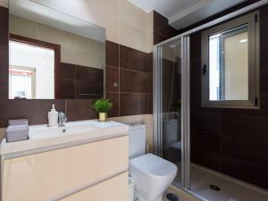 a bathroom with a toilet and a sink and a shower at Montevideo By CanariasGetaway in Guanarteme +23 photos