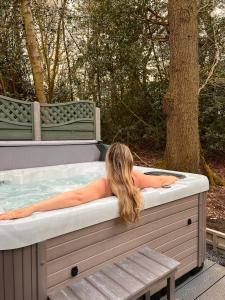 a girl laying in a jacuzzi tub at Southfield Shepards Huts in Durham