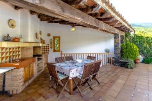 a kitchen with a table and chairs on a patio at Picturesque Costa Brava Countryside Villa in Les Planes d'Hostoles