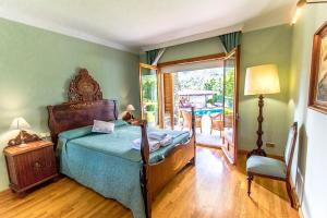 a bedroom with a bed and a table and a patio at Picturesque Costa Brava Countryside Villa in Les Planes d'Hostoles +37 photos