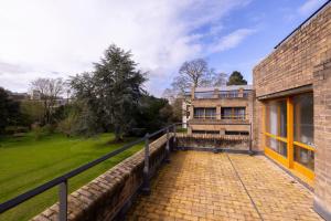 an exterior view of a brick building with a fence at Harvey Court Gonville and Caius College in Cambridge