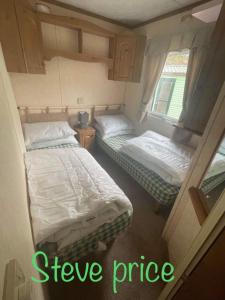 two twin beds in a small room with a sqor at Get aways in west wales in Llandysul