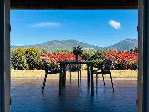 a table and chairs with a view of mountains at Dolce Vita in Propriano