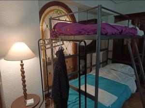 two bunk beds in a room with a lamp at Habitación Centro Only Mens in Madrid