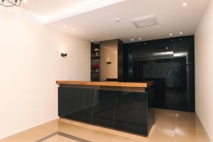 a kitchen with black cabinets and a counter at Miramar in Ulcinj