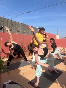 a group of people performing aorativeorativeorativeorative performance at Olympe Surf & Yoga in Tamraght Ouzdar